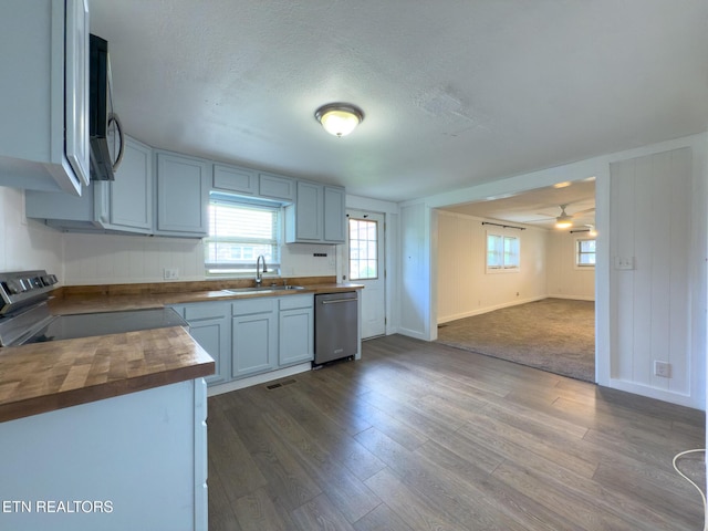 104 Church St, Loudon, TN 37774 - kitchen featuring butcher block countertops, stainless steel dishwasher, electric range oven, dark wood-style flooring, and a textured ceiling