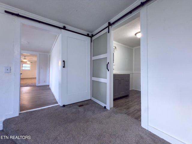 104 Church St, Loudon, TN 37774 - carpeted empty room featuring a barn door, wood finished floors, and ornamental molding