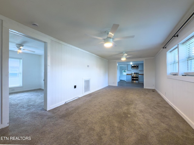 104 Church St, Loudon, TN 37774 - unfurnished living room featuring a ceiling fan, carpet, ornamental molding, and healthy amount of natural light