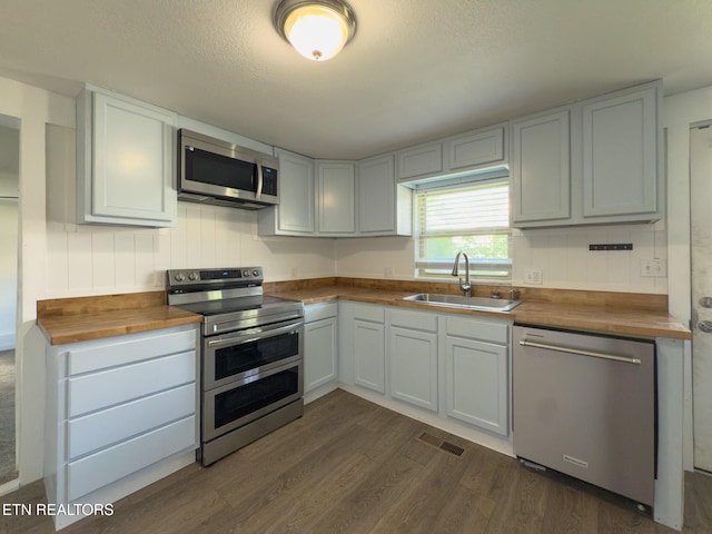 104 Church St, Loudon, TN 37774 - kitchen with stainless steel appliances, butcher block counters, dark wood-style flooring, and a textured ceiling