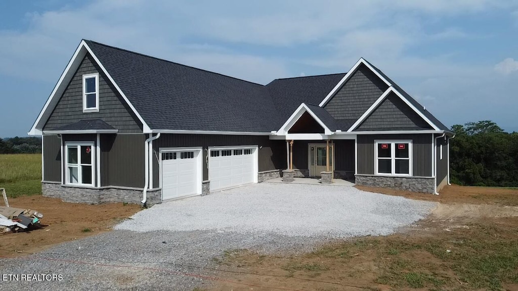 361 Meadow Rd, Greenback, TN 37742 - craftsman-style home with a garage, stone siding, driveway, and a shingled roof