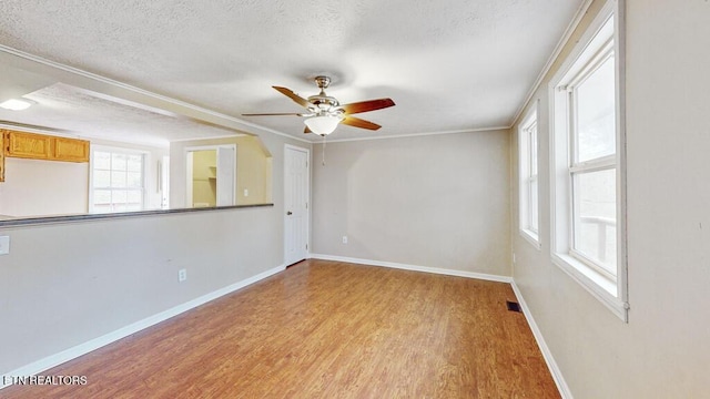 317 Hollifield Dr, Jacksboro, TN 37757 - empty room featuring a ceiling fan, a textured ceiling, light wood-type flooring, and baseboards