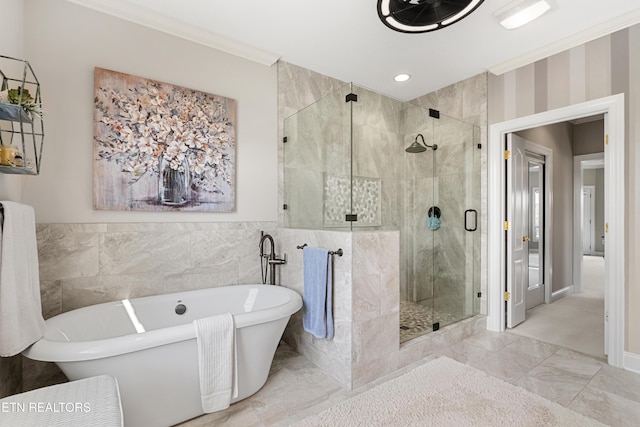 257 Osprey Cir, Vonore, TN 37885 - full bathroom featuring a freestanding bath, ornamental molding, marble look tile flooring, a stall shower, and tile walls