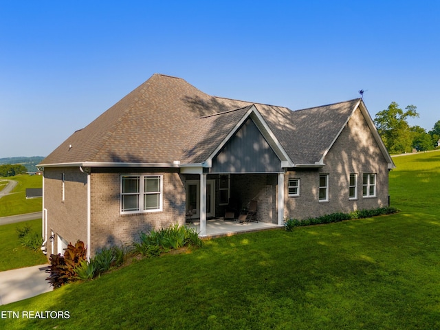 4153 Harbor View Dr, Morristown, TN 37814 - back of house with brick siding, a patio, a yard, an attached garage, and roof with shingles