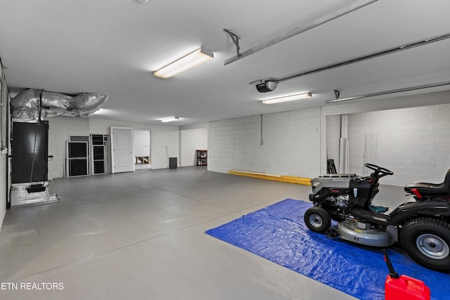 4153 Harbor View Dr, Morristown, TN 37814 - garage featuring a garage door opener and concrete block wall