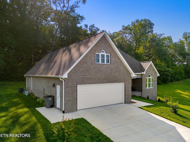 4153 Harbor View Dr, Morristown, TN 37814 - view of front of property with brick siding, a front yard, concrete driveway, and central AC