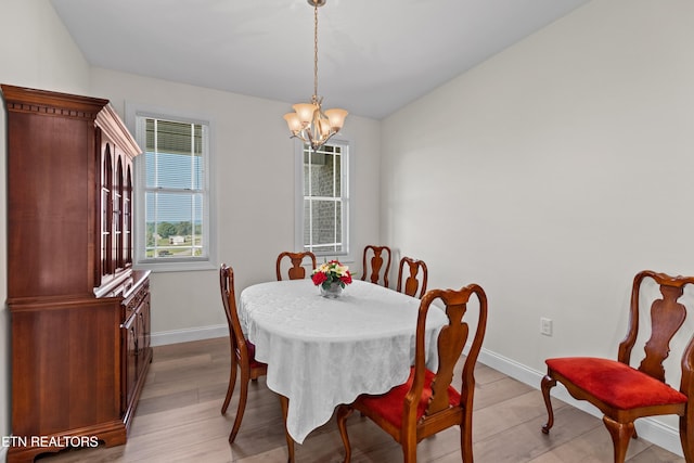 4153 Harbor View Dr, Morristown, TN 37814 - dining room featuring a chandelier, baseboards, and light wood-style flooring