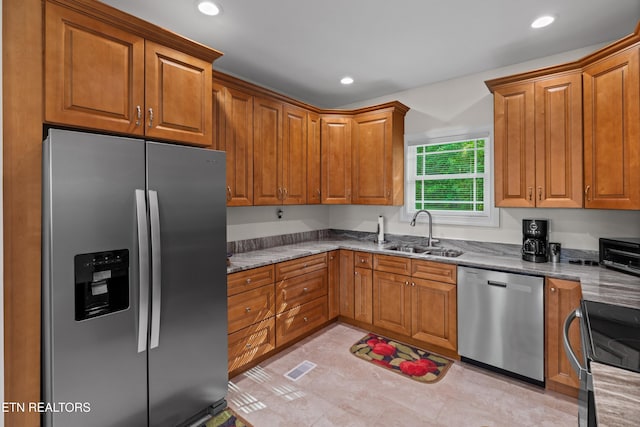 4153 Harbor View Dr, Morristown, TN 37814 - kitchen with stainless steel appliances, a sink, brown cabinetry, and recessed lighting