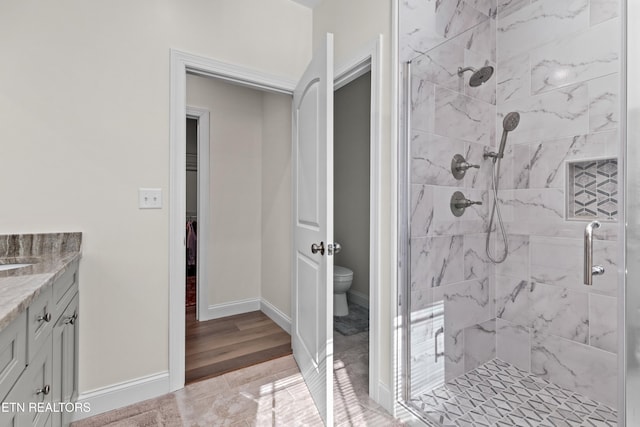 4153 Harbor View Dr, Morristown, TN 37814 - full bathroom featuring a stall shower, toilet, vanity, baseboards, and wood finished floors