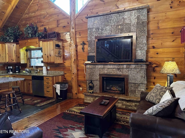 2738 Murray Ridge Rd, Sevierville, TN 37876 - living room featuring hardwood / wood-style floors, a fireplace, wood walls, and lofted ceiling
