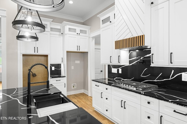 104 Noya Ln, Loudon, TN 37774 - kitchen with ornamental molding, tasteful backsplash, white cabinets, stainless steel gas stovetop, and light wood-type flooring