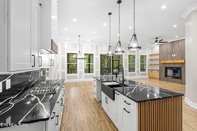 104 Noya Ln, Loudon, TN 37774 - kitchen featuring light wood-style floors, a sink, a fireplace, a ceiling fan, and a large island with sink