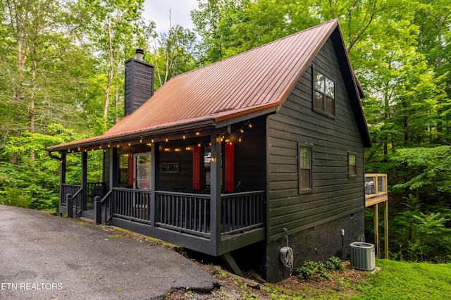 391 Laurel Rd, Townsend, TN 37882 - chalet / cabin with a porch, a chimney, metal roof, and central AC