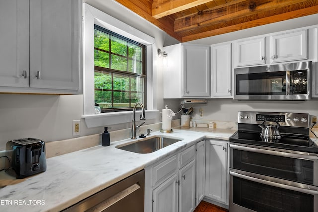 391 Laurel Rd, Townsend, TN 37882 - kitchen featuring appliances with stainless steel finishes, a sink, wood ceiling with exposed beams, light stone countertops, and white cabinetry
