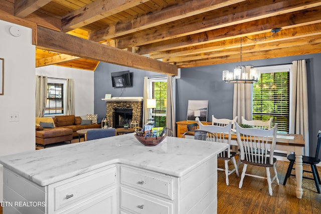 391 Laurel Rd, Townsend, TN 37882 - living room featuring dark wood-style flooring, wooden ceiling, plenty of natural light, a chandelier, and a stone fireplace