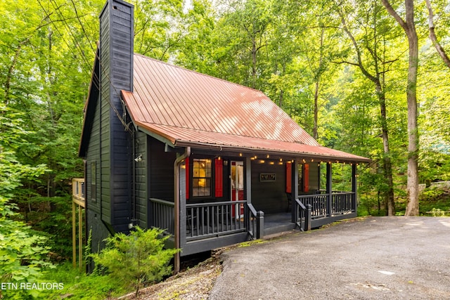 391 Laurel Rd, Townsend, TN 37882 - rustic home featuring a chimney, a porch, and metal roof