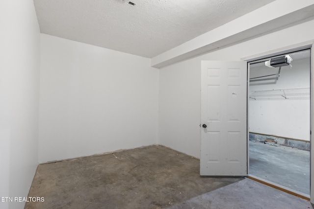 1720 Chesapeake Dr, Athens, TN 37303 - unfurnished bedroom featuring concrete floors, a closet, and a textured ceiling