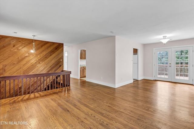 9209 Topoco Dr, Knoxville, TN 37922 - spare room with wood finished floors, wood walls, and french doors