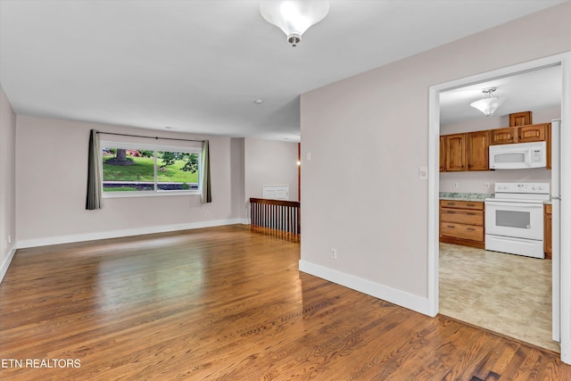 9209 Topoco Dr, Knoxville, TN 37922 - unfurnished living room with light wood finished floors and baseboards