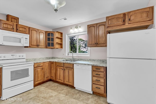 9209 Topoco Dr, Knoxville, TN 37922 - kitchen with white appliances, brown cabinetry, glass insert cabinets, and light stone countertops