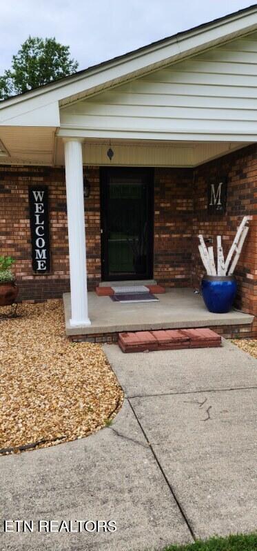 1922 Chaney Ridge Rd, London, KY 40741 - view of exterior entry featuring covered porch and brick siding