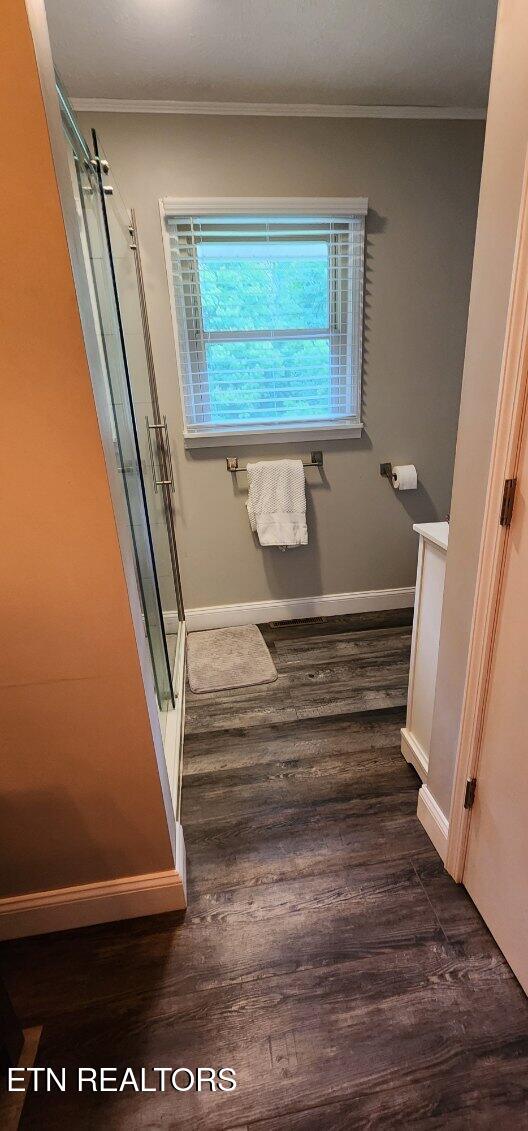 1922 Chaney Ridge Rd, London, KY 40741 - full bath with a stall shower, wood finished floors, crown molding, baseboards, and vanity