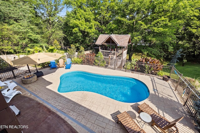 10513 River Ridge Rd, Knoxville, TN 37922 - view of swimming pool featuring a patio, view of wooded area, and a fire pit