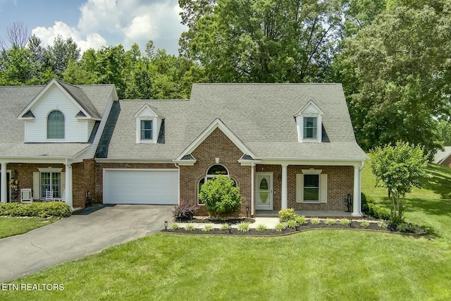 430 Willow Springs Dr, Athens, TN 37303 - cape cod-style house with driveway, brick siding, a porch, and a front lawn