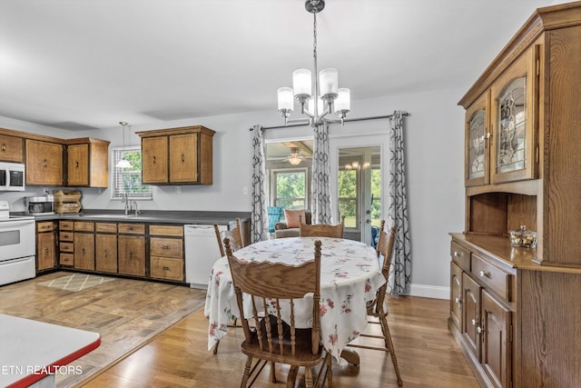 1670 Bowen Rd, Rutledge, TN 37861 - dining area with a chandelier, light wood-type flooring, and baseboards