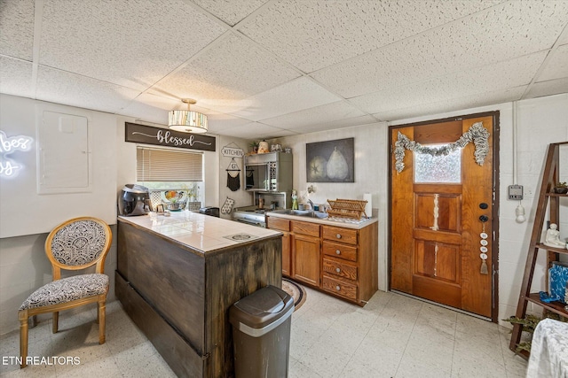 2059 Bolestown Loop, Alpine, TN 38543 - kitchen with a drop ceiling, light floors, stainless steel microwave, brown cabinets, and a peninsula