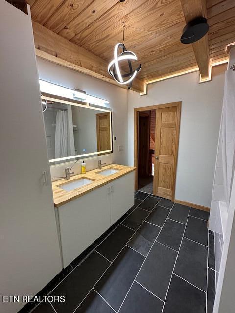 1015 Kizzy Patch Way, Del Rio, TN 37727 - full bathroom featuring wooden ceiling, double vanity, curtained shower, and baseboards