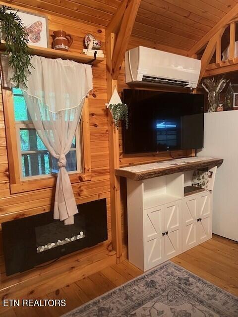 533 Valley Ridge Rd, Jamestown, TN 38556 - detailed view of wooden ceiling, a wall mounted air conditioner, wood finished floors, and wooden walls