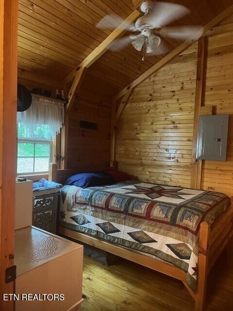 533 Valley Ridge Rd, Jamestown, TN 38556 - bedroom with electric panel, wood walls, vaulted ceiling, wood ceiling, and hardwood / wood-style flooring