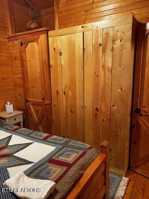 533 Valley Ridge Rd, Jamestown, TN 38556 - bedroom featuring wooden walls, light wood-style floors, and a closet