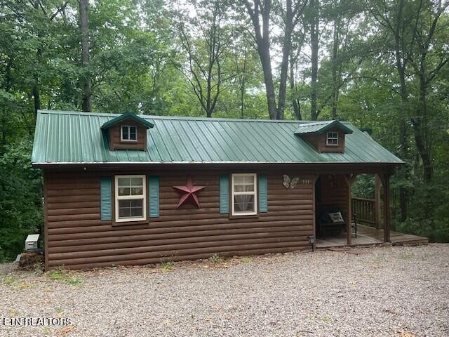 533 Valley Ridge Rd, Jamestown, TN 38556 - view of front of property featuring log veneer siding, metal roof, and view of wooded area