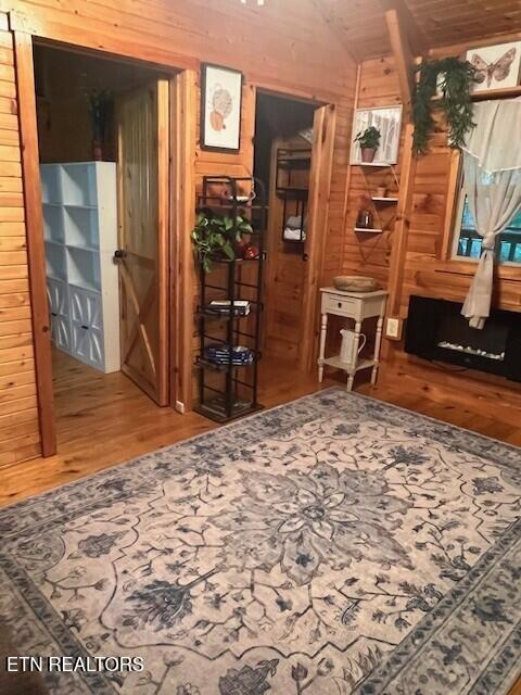 533 Valley Ridge Rd, Jamestown, TN 38556 - sitting room featuring wood finished floors, wooden walls, and vaulted ceiling