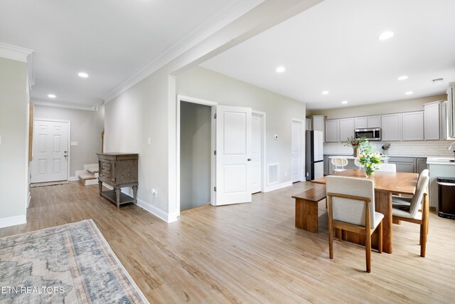 8104 Equinox Ln, Powell, TN 37849 - dining space featuring light wood-type flooring, ornamental molding, baseboards, recessed lighting, and stairway