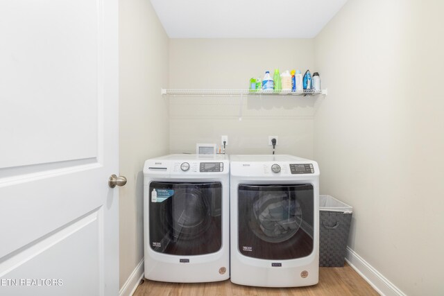 8104 Equinox Ln, Powell, TN 37849 - laundry room featuring washer and dryer, wood finished floors, and baseboards