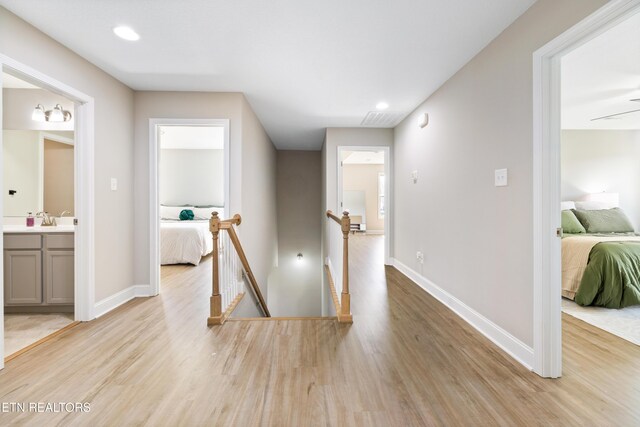 8104 Equinox Ln, Powell, TN 37849 - corridor featuring an upstairs landing, light wood finished floors, baseboards, a sink, and recessed lighting