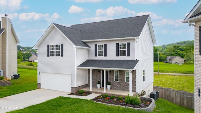 8104 Equinox Ln, Powell, TN 37849 - traditional-style home with a porch, a garage, concrete driveway, cooling unit, and a shingled roof