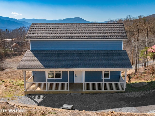 1108 Circle Pt, Gatlinburg, TN 37738 - view of front of home with a mountain view, a porch, and roof with shingles