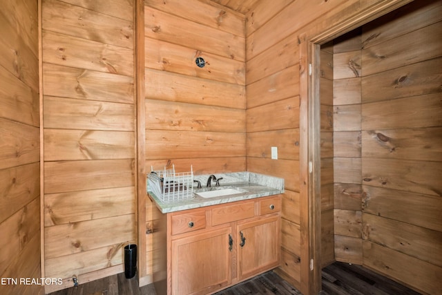 1108 Circle Pt, Gatlinburg, TN 37738 - bathroom featuring vanity, wood walls, and wood finished floors