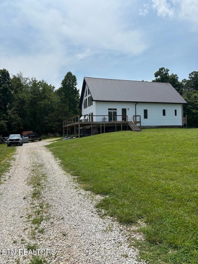 264 Victory Cross Rd, Lafollette, TN 37766 - view of front of house with gravel driveway, a metal roof, a front yard, and a deck