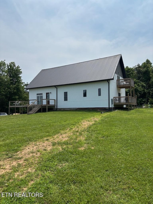 264 Victory Cross Rd, Lafollette, TN 37766 - back of house featuring a metal roof, a wooden deck, and a lawn