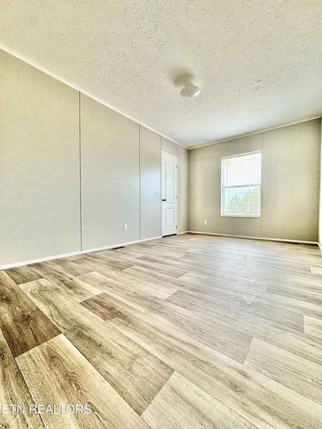 320 Perkey Way, Tazewell, TN 37879 - unfurnished room with light wood-type flooring, a textured ceiling, and baseboards