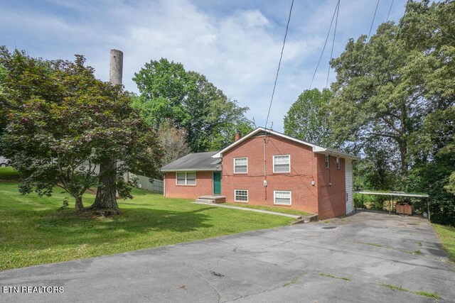2001 Highland Rd, Maryville, TN 37801 - view of home's exterior with brick siding, a lawn, driveway, and a carport
