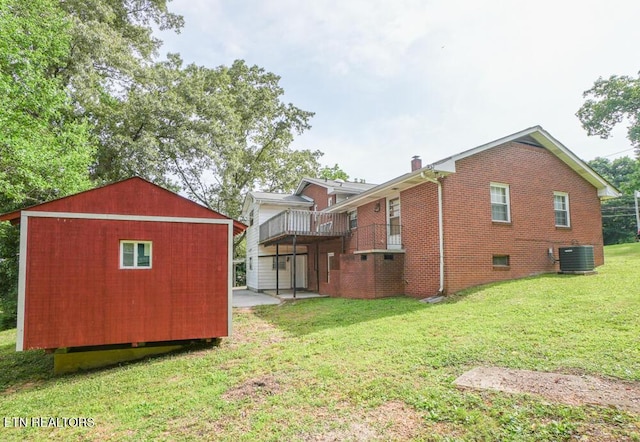 2001 Highland Rd, Maryville, TN 37801 - view of side of property featuring a lawn, a wooden deck, central air condition unit, brick siding, and an outbuilding