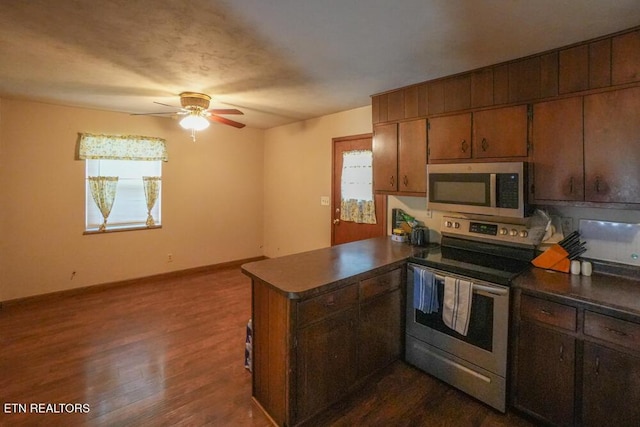 2001 Highland Rd, Maryville, TN 37801 - kitchen with appliances with stainless steel finishes, a peninsula, dark countertops, and a ceiling fan