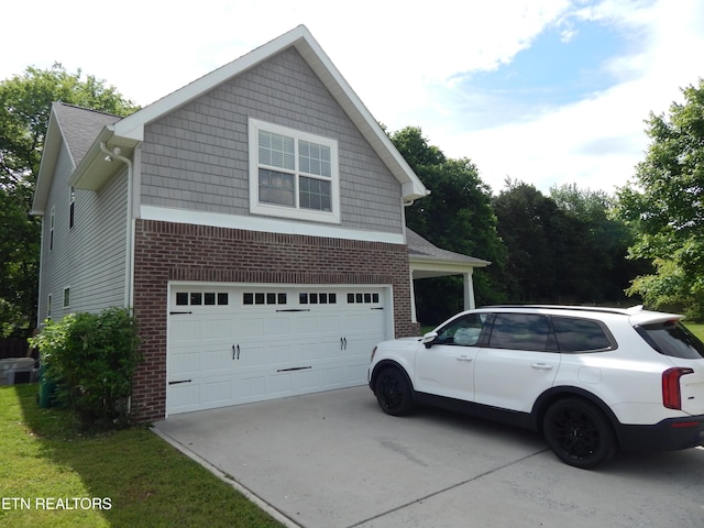 9100 Sway Branch Ln, Knoxville, TN 37922 - view of property exterior with brick siding, a garage, and concrete driveway
