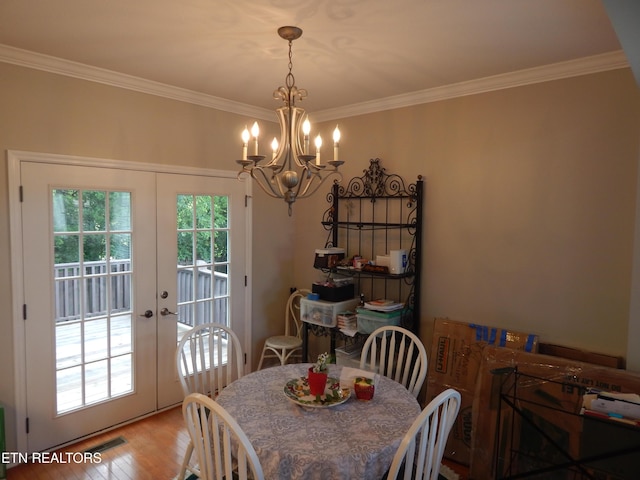 9100 Sway Branch Ln, Knoxville, TN 37922 - dining room with french doors, a chandelier, ornamental molding, and wood finished floors